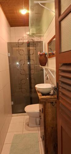 a bathroom with a shower and a toilet and a sink at Casa de Lorna 2 in Rio de Janeiro