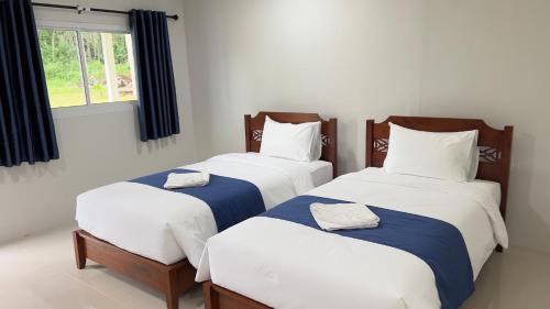 Ένα ή περισσότερα κρεβάτια σε δωμάτιο στο Koh Yao unnrak Resort