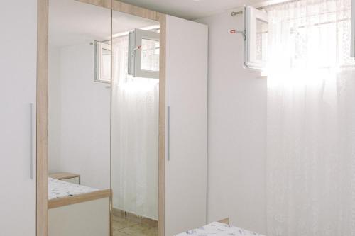 a bathroom with a shower and a mirror at Large and charming apartment near beach with big & sunny terrace in Sumartin