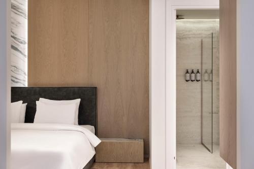 a bedroom with a bed and a walk in shower at Nur City Suites in Athens