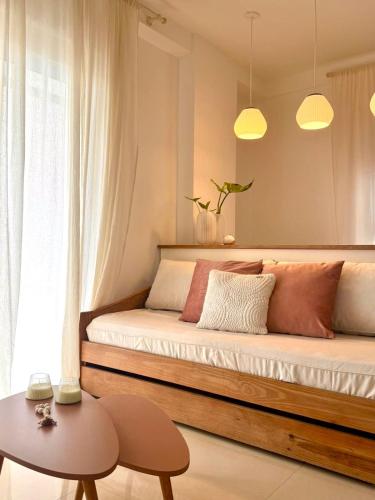 a bed with two pillows and a table in a room at Capibara 6 - Vistas de Junin in Corrientes