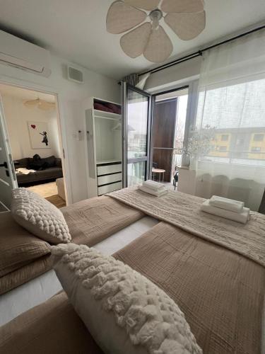 a bedroom with a large bed with a ceiling fan at SPV Rentals Pileckiego 59 lokal 258 free Parking Ursynów in Warsaw