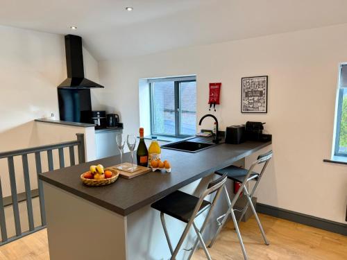 a kitchen with a counter with a bowl of fruit on it at Malvern Retreat In The Hills, 1 Bedroom, Cradley in Cradley