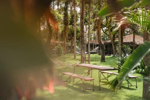 a group of picnic tables and chairs in a park at Mtoni River Lodge in Arusha