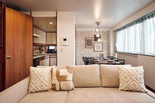 a living room and kitchen with a couch and a table at Noël Shibuya Once -Luxury Residence in Tokyo