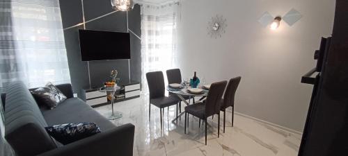 a living room with a couch and a table with chairs at Good Place Kodowa in Skorka