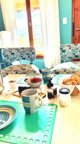 a table with a cup of coffee and a plate of food at Los Saucos in El Hoyo