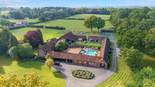 an aerial view of a house with a swimming pool at Weston Cottage 4 in Send