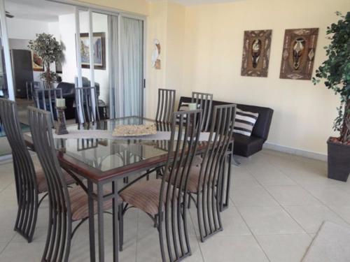 a dining room with a glass table and chairs at Arabella No. 4 in Margate