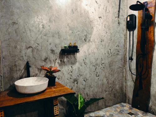 a bathroom with a sink on a concrete wall at Laeley 1,000 miles resort in Ko Lanta Yai