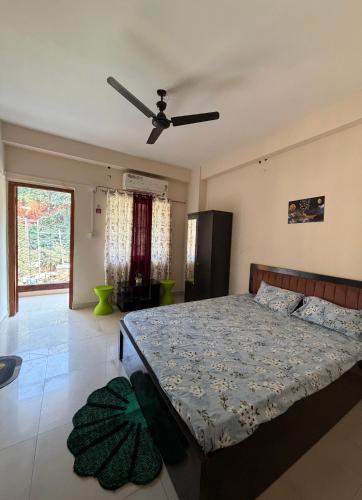 a bedroom with a bed and a ceiling fan at Da Nest in Guwahati