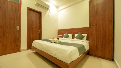 a bedroom with a bed with two towels on it at The Namami Tapovan in Rishīkesh