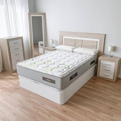 a bed in a bedroom with two night stands and two tables at Recidencial in Mendoza