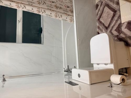 a white computer on a glass table in a room at Warn Cossy Luxe Room in Addington