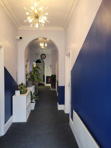 a hallway of an office with a blue wall at Nysdill Accommodation in Norwich