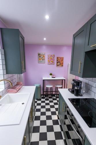 a kitchen with a black and white checkered floor at Checkered Wonderland at 19 Milbanke in Doncaster