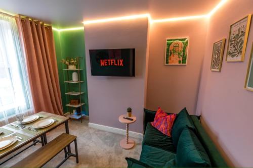 a living room with a green couch and a table at Checkered Wonderland at 19 Milbanke in Doncaster