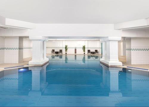 a large swimming pool with columns in a building at Between Piers, the stylish studio flat in Cannon place in Brighton & Hove