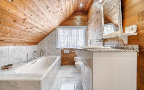 a bathroom with a tub and a sink at Villa Carlitos by Villas Vista Gomera in Adeje