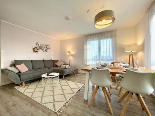 a living room with a couch and a table at Apartment Rooftop - Dresden trifft Sächsische Schweiz! in Dresden