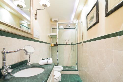a bathroom with a sink and a shower at Old Tower Ponte Vecchio Suite in Florence