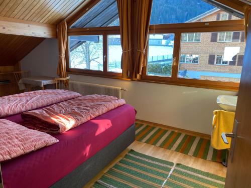 Haus Margret في ميلاو: غرفة نوم بسريرين في غرفة بها نوافذ