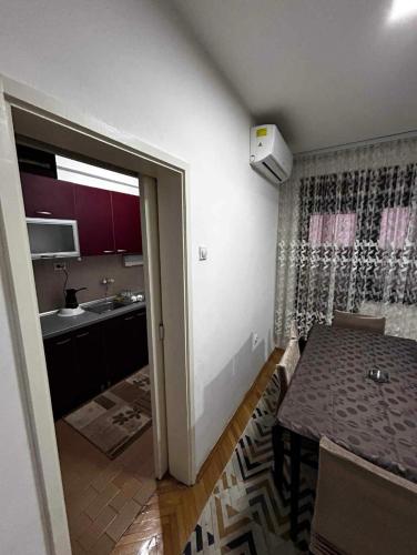 a kitchen and dining room with a table and a dining room at M comfort in Kumanovo