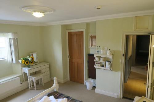 a room with a kitchen with a sink and a stove at The Helyar Arms in Yeovil