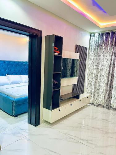a bedroom with a bed and a tv in a room at Fadaka Manor in Ibadan