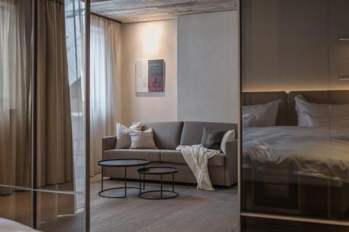 a living room with a couch and a bed at Alpvita Piz Tasna in Ischgl