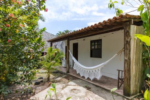 ein Haus mit einer Hängematte draußen in der Unterkunft Flat Flor da Terra in Itacaré