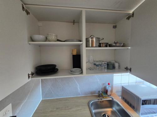 a kitchen with a sink and a counter top at Central studio apartment stgallen gratis Parkplatz in St. Gallen