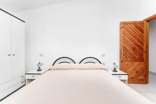 Una cama o camas en una habitación de Appartamento in villa 5 posti letto