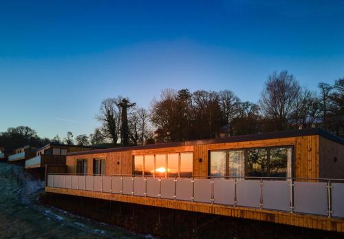a house on the side of a river at The Mole Resort - Lodges in Chittlehamholt