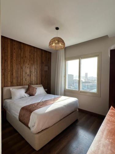 a bedroom with a large bed and a window at Elevana Boutique hotel in Cairo