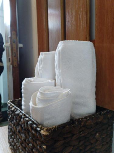a basket filled with white towels in a room at Pensiune Supca in Râmnicu Vâlcea