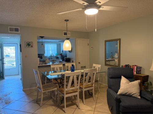 a dining room and living room with a table and chairs at Latitude 107 2 bedroom walk to beach in Orange Beach