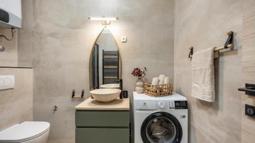 a bathroom with a washing machine and a sink at Holiday house Hedonica by Villas Guide in Mirlović Zagora