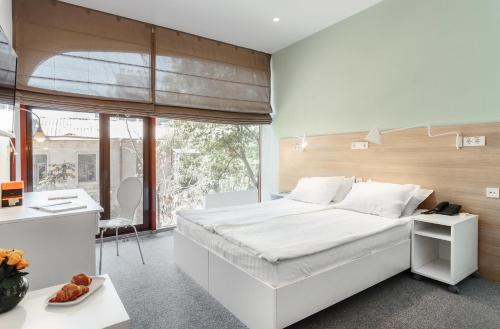 Postel nebo postele na pokoji v ubytování Orange Hotel