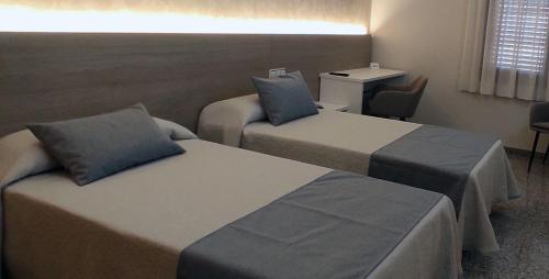 Postel nebo postele na pokoji v ubytování Hostal Empresarial Talca