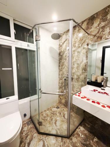 a bathroom with a shower and a toilet at Golden Hotel in Hanoi