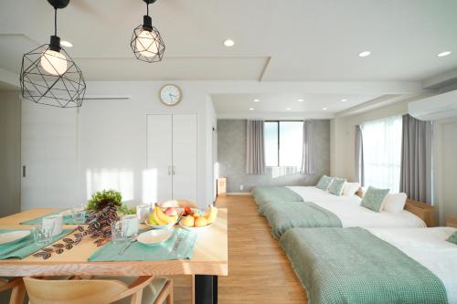 a room with two beds and a table with fruit on it at Unite Stay Urayasu201 Close to Disneyland, 15 minutes by bus, 8 minutes by car, and good access from the nearest station to Tokyo Station, Ginza, and Asakusa in Tokyo