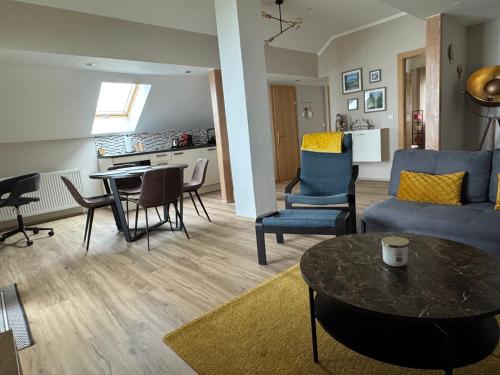 a living room with a couch and a table and chairs at Danny's Wörtherseeblick in Schiefling am See