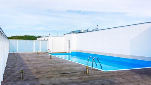 a swimming pool on the roof of a building at Apartament 208 in Międzyzdroje