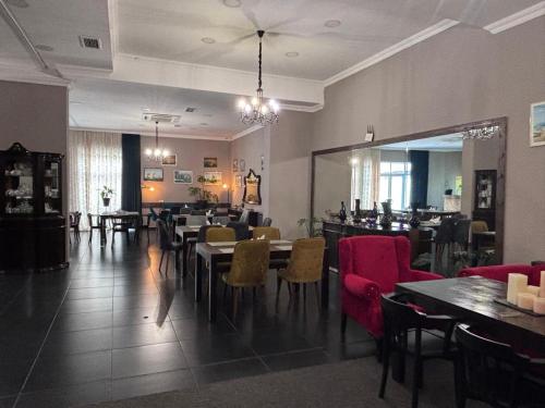 a dining room with tables and chairs in a restaurant at Aura Boutique Hotel in Batumi