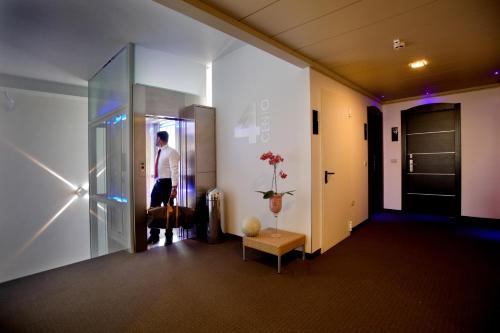 a man standing at the door of a building at Hotel Panama Majestic in Rimini