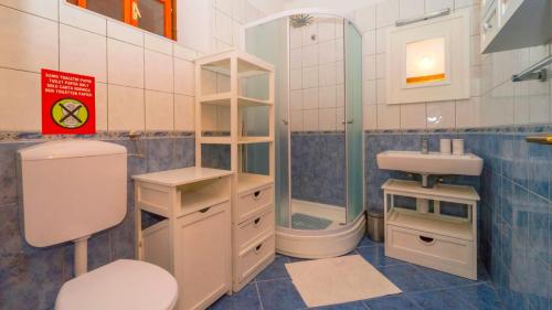 een badkamer met een toilet, een wastafel en een douche bij Villa SMOQUIZZA by Villas Guide in Smokvica