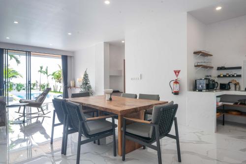 a dining room with a wooden table and chairs at Gandum Villa Complex - Luxury Boutique Stay Uluwatu in Uluwatu