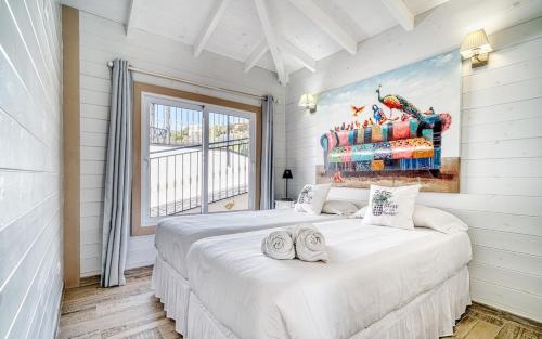 a bedroom with a large white bed and a window at Villa Karla by Villas Vista Gomera in Adeje