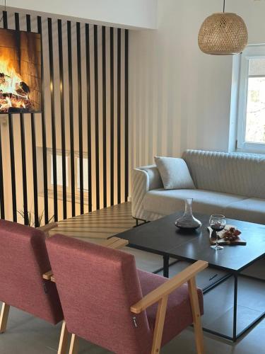 a living room with a couch and a table at Vacation Home Mo Star with Swimming pool and Sauna in Mostar
